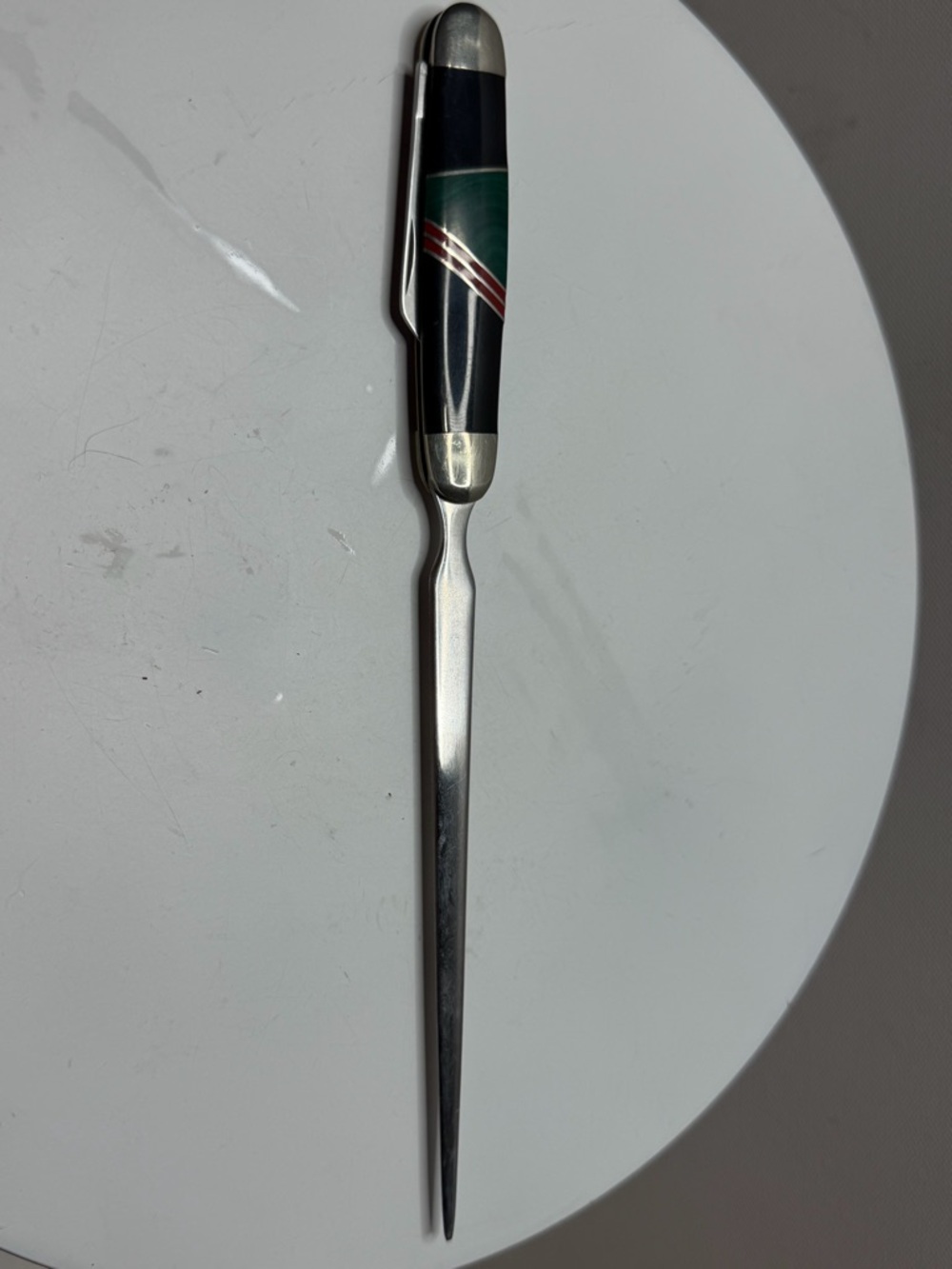 A letter opener with decorative trim.